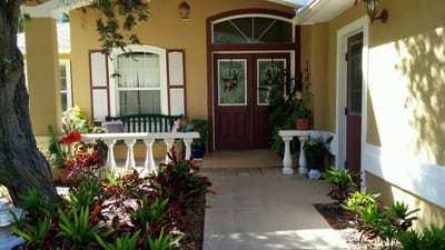 Inviting entrance with lush plants and seating area