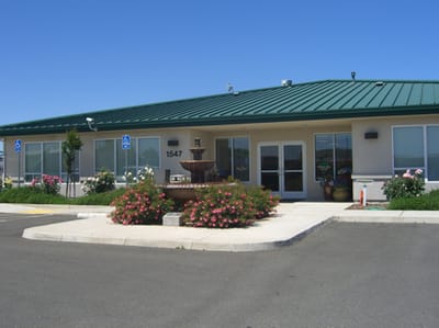 Exterior view of Willow Glen Care Center with flowers