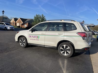 Facility transport vehicle in parking lot