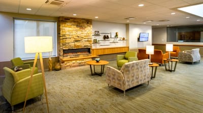 Cozy common area with seating and a fireplace.
