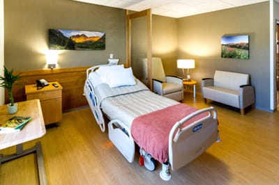 Cozy hospital room with a bed and sitting area
