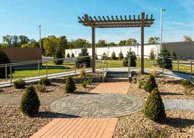Outdoor garden area with a pergola and pathways.