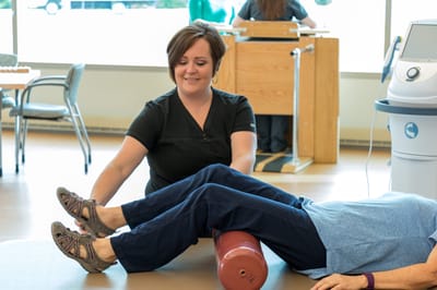 Therapy session with staff assisting a resident