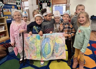 Group of children celebrating with a colorful poster