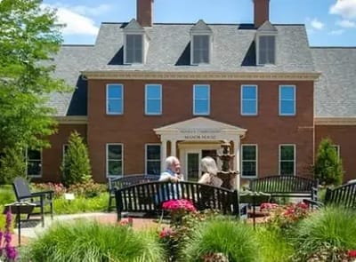 Two residents enjoying the garden outside the facility.
