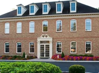 Exterior view of a brick building with landscaping.