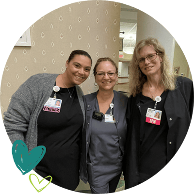 Three staff members smiling in the facility