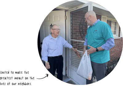 Volunteer delivering food to an elderly resident.