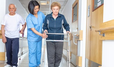 Staff assisting residents with mobility