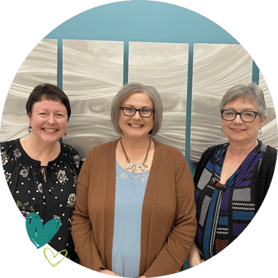 Three staff members in a common area.