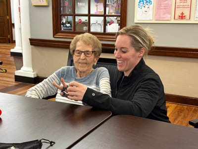 Senior resident engaging with staff member