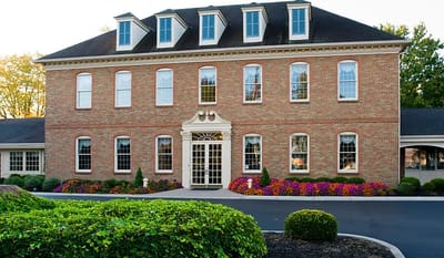 Exterior view of a brick nursing home facility.