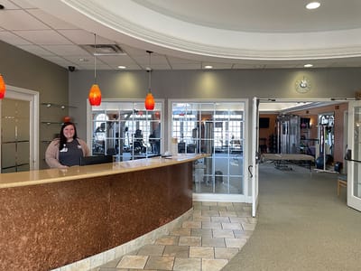 Reception area with staff member at the desk.