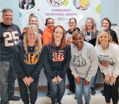 Staff members posing together in a common area.
