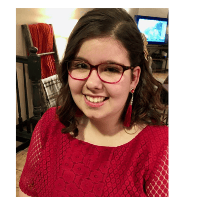 Young woman smiling in a red dress.