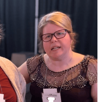 Two women talking at an event.