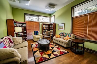 Comfortable common area with seating and bookshelves
