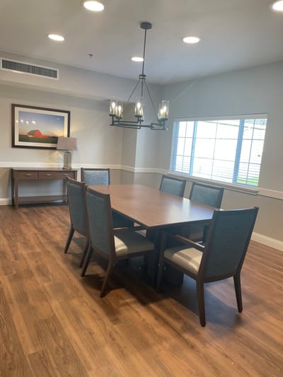 Bright common area with dining table and chairs