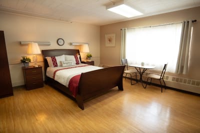 Cozy private resident room with bed and seating area