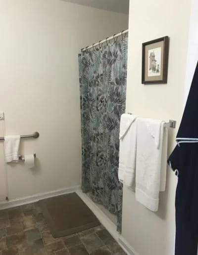 Interior view of a bathroom with a shower and towels