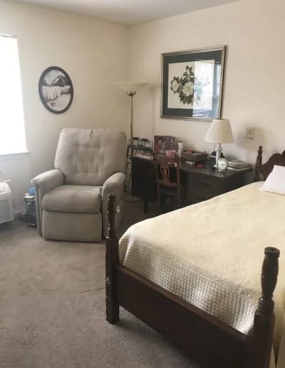 Private resident room with bed and chair