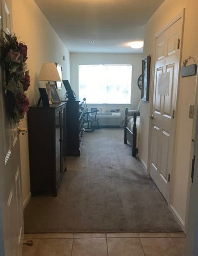 Hallway in a senior living facility with room doors
