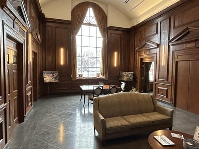 Interior view of a common area with wood paneling and seating