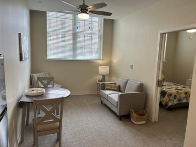 Cozy interior of a resident room with seating and a bed