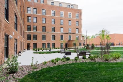 Exterior view of Bardwell Residences with outdoor seating area