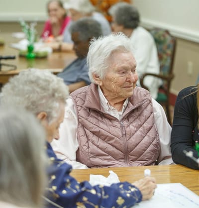 Residents engaging in conversation at a communal table