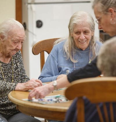 Residents enjoying a game around a table
