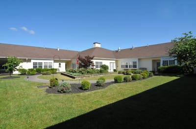 Exterior view of a landscaped assisted living facility