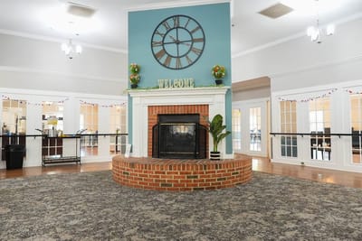 Interior view of a welcoming common area with fireplace