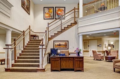 Interior view of a lobby with stairs and seating areas