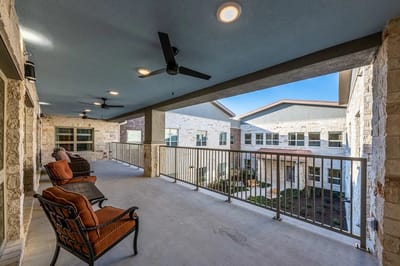 Covered outdoor porch area with seating