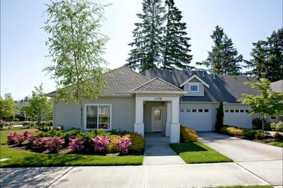 Exterior view of a single-story facility building with landscaped garden