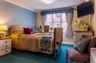 Cozy resident room with bed and seating area