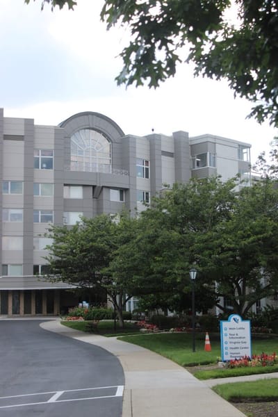 Exterior view of Wesley Glen facility surrounded by greenery