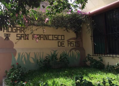 Exterior view of Hogar San Francisco entrance with plants