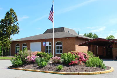 View of the facility building with landscaped gardens
