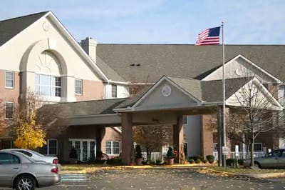 The entrance of The Waterford at St. Luke with a flag