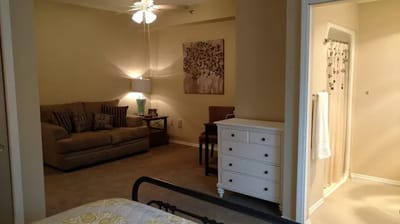 Cozy interior of a resident room with a couch and dresser