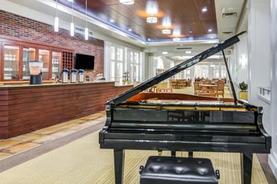 Common area with a piano and bar