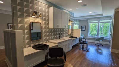 Hair salon area with chairs and mirrors