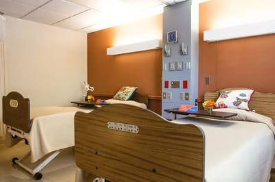 Brightly lit resident room with twin beds and decor