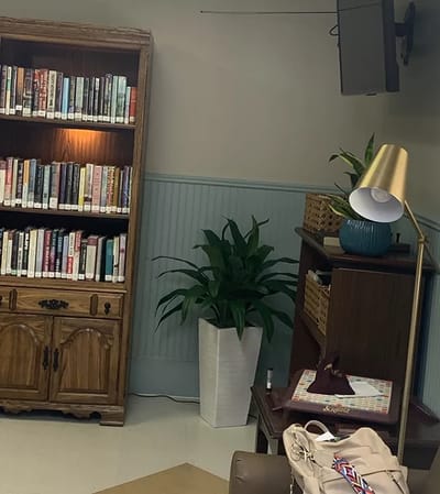 Cozy library corner with books and plants
