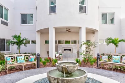 Outdoor courtyard with seating and a water fountain