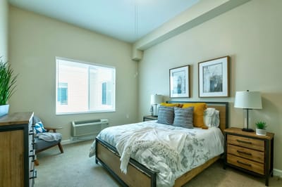 A cozy resident room with a bed and window