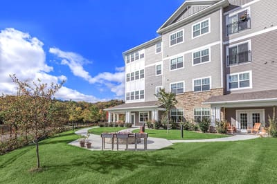 Exterior view of a senior living facility with landscaped garden