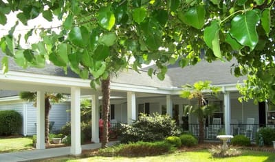 Exterior view of the facility with garden and porch